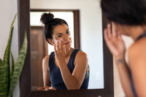 Confident woman with good skin using skincare.