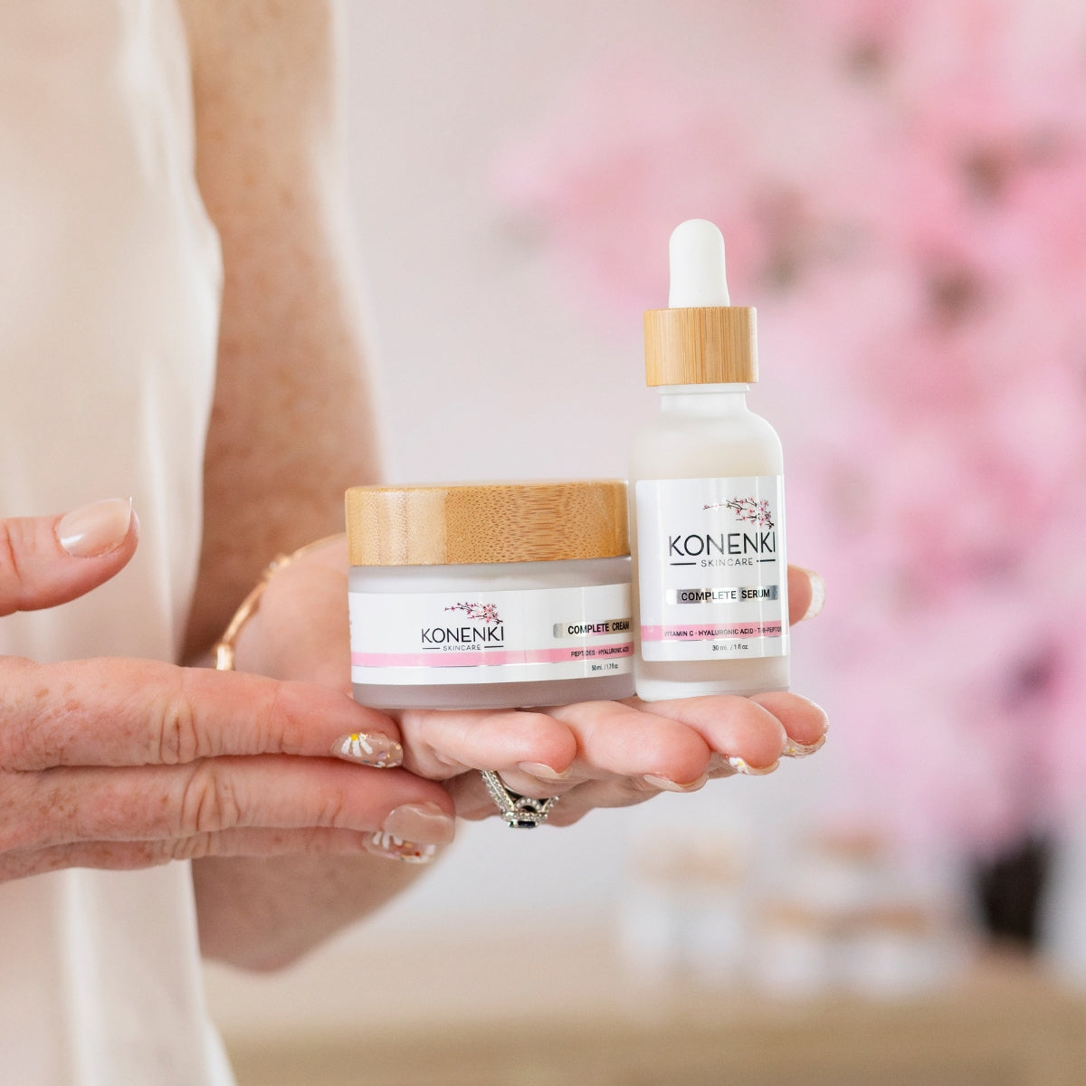 A closeup of Konenki Skincare founder Alana Palmer holding her two flagship products: the Konenki Complete Cream and the Konenki Complete Serum.
